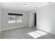 Well-lit bedroom with gray wood-look tile and neutral walls at 3020 E Louisiana Ave, Tampa, FL 33610
