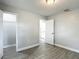 Cozy bedroom showcases wood-look tile flooring, and doorways to bathroom and closet at 3020 E Louisiana Ave, Tampa, FL 33610