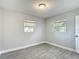 Clean bedroom with wood-look tile, natural light from two windows, and fresh paint at 3020 E Louisiana Ave, Tampa, FL 33610
