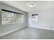 Bright and airy bedroom with ample natural light and wood-look tile flooring at 3020 E Louisiana Ave, Tampa, FL 33610
