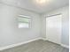 Bedroom featuring gray wood-look tile flooring and a closet at 3020 E Louisiana Ave, Tampa, FL 33610