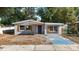 Charming single-story home with blue door and light-grey paint on a sunny day at 3020 E Louisiana Ave, Tampa, FL 33610