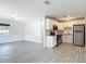 Open-concept kitchen featuring modern white cabinets and stainless steel appliances at 3020 E Louisiana Ave, Tampa, FL 33610