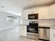 Open concept kitchen with modern stainless appliances and granite countertops at 3020 E Louisiana Ave, Tampa, FL 33610