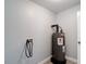 A utility room with a new hot water heater with gray tile floor at 3020 E Louisiana Ave, Tampa, FL 33610