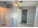 A clean bedroom with light gray walls, large windows, and a ceiling fan at 342 51St N Ave, St Petersburg, FL 33703
