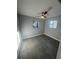 Comfortable bedroom featuring neutral gray walls, two windows, and gray tile flooring at 342 51St N Ave, St Petersburg, FL 33703