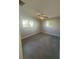 Bright bedroom features neutral walls, two windows, ceiling fan, and gray tile flooring at 342 51St N Ave, St Petersburg, FL 33703