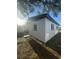 Rear exterior view of a white home with gray trim and well-maintained lawn at 342 51St N Ave, St Petersburg, FL 33703