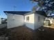 Rear exterior view of a freshly painted white home with gray trim at 342 51St N Ave, St Petersburg, FL 33703