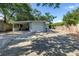View of the rear of the property including a large driveway and covered carport at 3510 4Th N Ave, St Petersburg, FL 33713