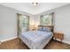 Comfortable bedroom featuring a wooden bed frame, natural light, and wooden flooring at 3510 4Th N Ave, St Petersburg, FL 33713