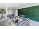 Rear covered patio with comfortable lounge seating and a tranquil garden wall at 3510 4Th N Ave, St Petersburg, FL 33713