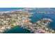 A high-angle aerial of a coastal neighborhood featuring waterfront homes, canals, and city views at 368 41St Ave, St Pete Beach, FL 33706