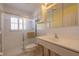A full bathroom with a glass door shower, a vanity, and white tile at 368 41St Ave, St Pete Beach, FL 33706