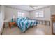 Bright bedroom with blue bedding, two windows, and a ceiling fan at 368 41St Ave, St Pete Beach, FL 33706