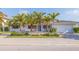 Charming single-story home featuring a manicured lawn, vibrant landscaping, and a paved driveway at 368 41St Ave, St Pete Beach, FL 33706