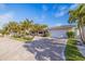 Beautiful single-story home boasts lush landscaping, a paver driveway, and an attached garage at 368 41St Ave, St Pete Beach, FL 33706