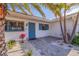 Inviting front entrance with a bright blue door, lush landscaping, and charming stone pathway at 368 41St Ave, St Pete Beach, FL 33706