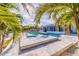 Tropical landscaping surrounds a refreshing pool and patio area with adjacent screened in porch at 368 41St Ave, St Pete Beach, FL 33706
