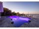 Waterfront home featuring a stunning pool with vibrant LED lights and coastal views at 368 41St Ave, St Pete Beach, FL 33706