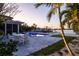 Beautiful pool and outdoor patio area with palms, manicured landscaping, and waterfront views at 368 41St Ave, St Pete Beach, FL 33706