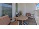 Cozy outdoor balcony offers a casual seating area with wicker chairs and a wooden table, perfect for relaxing at 375 Madeira Cir, St Petersburg, FL 33715