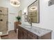 Tastefully designed bathroom showcasing modern lighting, brick-look shower, and granite countertop at 375 Madeira Cir, St Petersburg, FL 33715