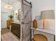 Bathroom features barn door, granite counters, and modern decor at 375 Madeira Cir, St Petersburg, FL 33715