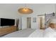 Inviting bedroom featuring an open doorway, an exposed sliding barn door, and contemporary decor at 375 Madeira Cir, St Petersburg, FL 33715