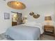 A comfortable bedroom features a decorative light fixture and a barn door to the bathroom at 375 Madeira Cir, St Petersburg, FL 33715