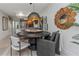 Modern dining room features an attractive light fixture, wood table, and decor at 375 Madeira Cir, St Petersburg, FL 33715