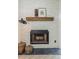Elegant stone fireplace with a wooden mantel adds warmth and character to the living space at 375 Madeira Cir, St Petersburg, FL 33715