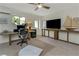 Well-lit office space with ceiling fan, mini-fridge, and built in TV at 375 Madeira Cir, St Petersburg, FL 33715