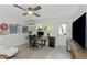 Well-lit office space with fan, a modern desk setup, and gallery wall for an inspiring workspace at 375 Madeira Cir, St Petersburg, FL 33715