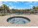 Community pool area with chairs, umbrellas, and lush tropical landscaping at 375 Madeira Cir, St Petersburg, FL 33715