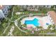 Aerial view of community pool, outdoor kitchen, and manicured landscaping at 375 Madeira Cir, St Petersburg, FL 33715