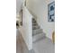Carpeted stairway leading to the upper level, with light wood flooring at 375 Madeira Cir, St Petersburg, FL 33715