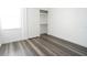 Bedroom features wood-look floors, natural light, and closet at 3803 N Oak Dr # B21, Tampa, FL 33611