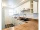 Cozy kitchen featuring white appliances, wood countertops, and ample cabinet space at 3803 N Oak Dr # B21, Tampa, FL 33611