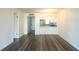 Open living room layout featuring wood-look flooring and kitchen view at 3803 N Oak Dr # B21, Tampa, FL 33611