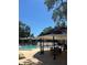Community pool featuring ample lounge seating, shaded cabana, and meticulously landscaped grounds with beautiful mature trees at 3803 N Oak Dr # B21, Tampa, FL 33611