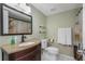 Bathroom features a wood vanity, granite countertop, stylish mirror, and ceramic tile flooring at 403 Saint Petersburg W Dr, Oldsmar, FL 34677