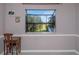 Bedroom featuring natural light from a large window, neutral walls, and small desk at 403 Saint Petersburg W Dr, Oldsmar, FL 34677