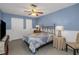 Blue bedroom featuring a ceiling fan, neutral furniture, and white wainscoting at 403 Saint Petersburg W Dr, Oldsmar, FL 34677
