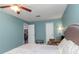 Well-lit bedroom with fresh light blue walls, offering a tranquil and inviting space to relax and unwind at 403 Saint Petersburg W Dr, Oldsmar, FL 34677
