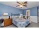 Light-filled bedroom with blue walls, wainscoting, and connected bathroom at 403 Saint Petersburg W Dr, Oldsmar, FL 34677