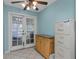 Bright bedroom with French doors and a view of a screened-in back porch offering indoor-outdoor living at 403 Saint Petersburg W Dr, Oldsmar, FL 34677