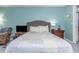 Well-lit bedroom with fresh light blue walls, offering a tranquil and inviting space to relax and unwind at 403 Saint Petersburg W Dr, Oldsmar, FL 34677