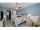 Comfortable bedroom with blue walls, tile floors, and a vintage-style metal bed frame at 403 Saint Petersburg W Dr, Oldsmar, FL 34677